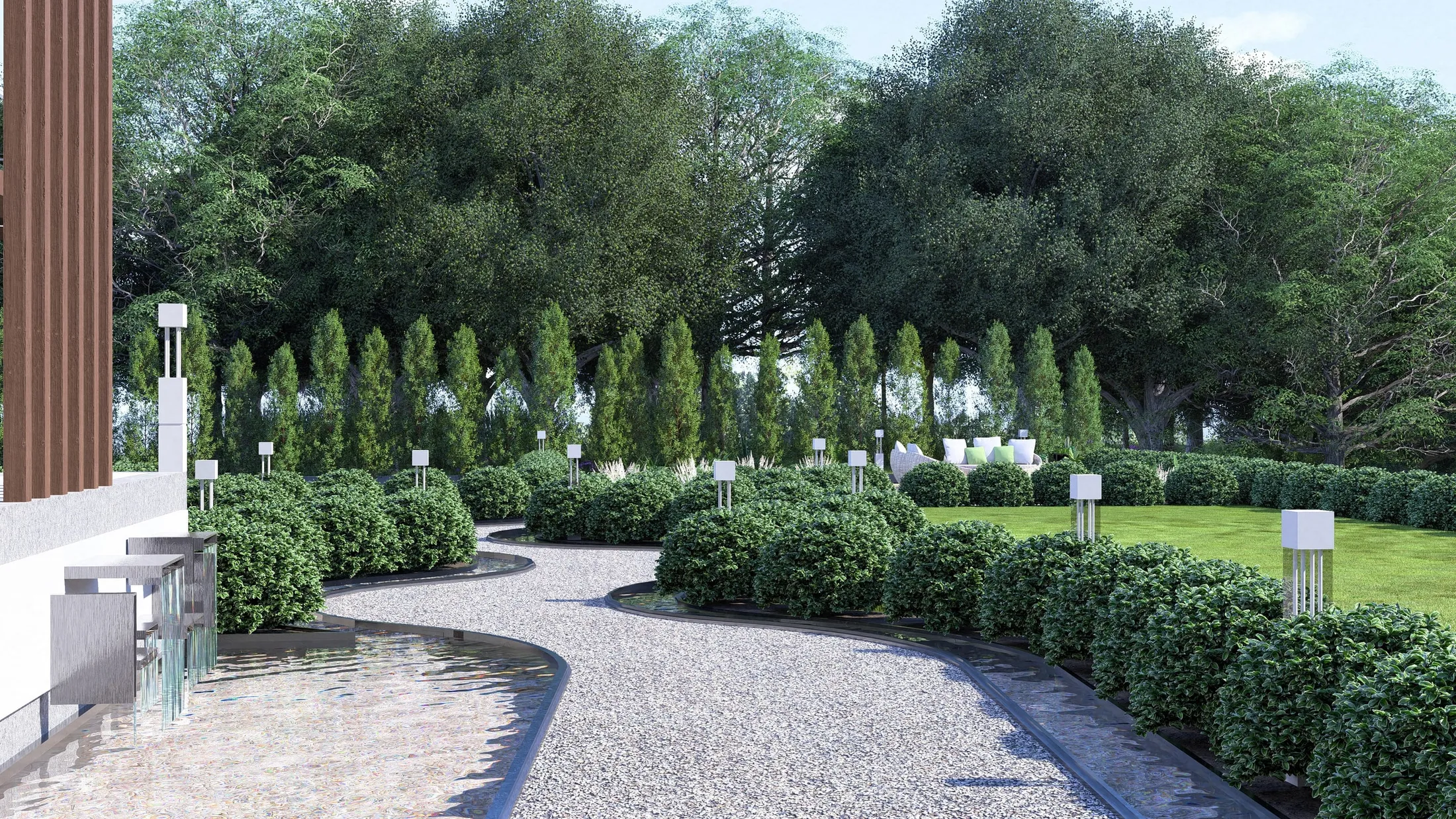 Winding gravel path with a water rill along the house and clipped shrubs